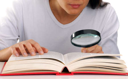 Woman with magnifying glass and bookの写真素材