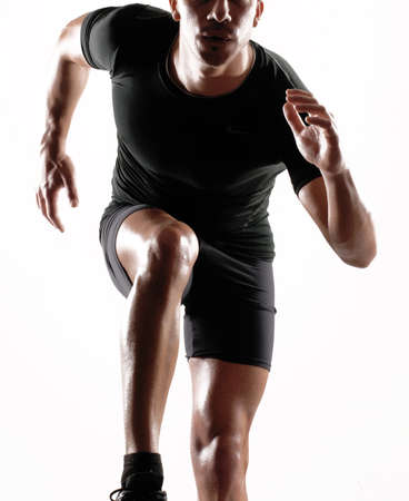 Portrait of a runner on white background の写真素材