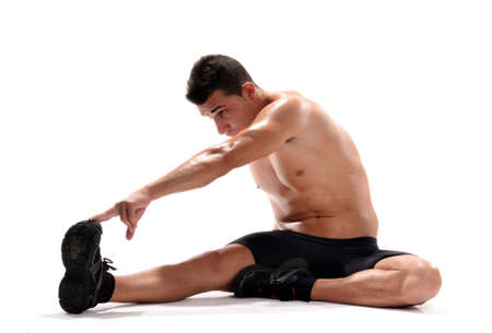 Healthy and strong man stretching his legの写真素材