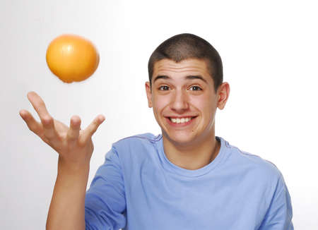 young man throwing an orange 