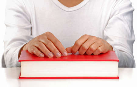 Female puts her hand on the book の写真素材