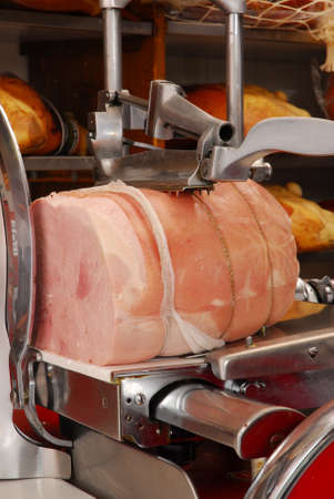 Ham slicer and prosciutto ham in a butcher shopの写真素材