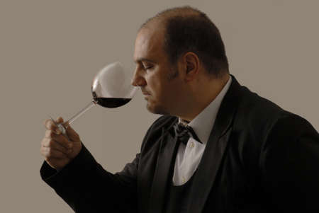 Young sommelier is tasting the red wineの写真素材