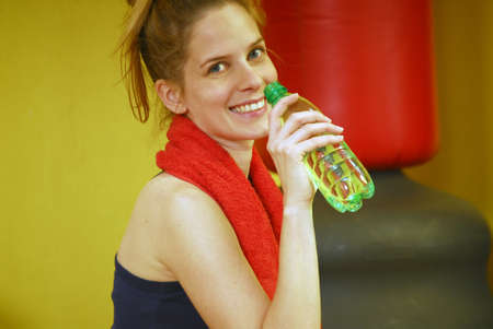 Young blonde woman is holding a water bottle の写真素材