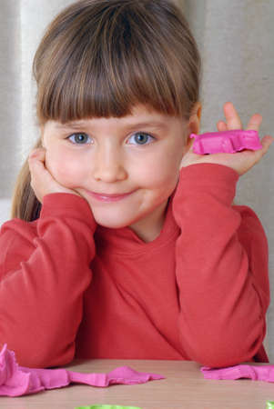 Little girl playing with clayの写真素材