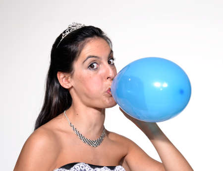 Bride blowing balloon