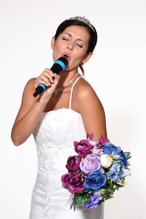 Bride holding flowers and singingの写真素材