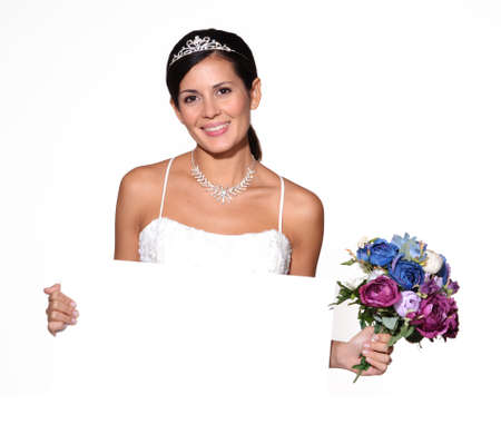 Bride holding a bouquet of flowers and blank boardの写真素材