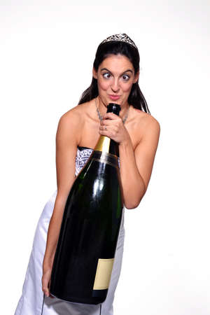 Bride holding a bottle of champagneの写真素材