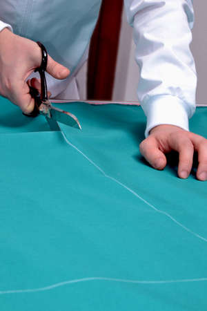 A tailor cutting fabric