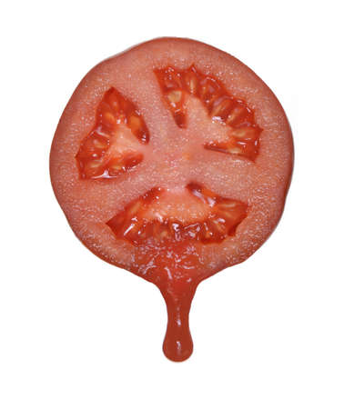 Sliced tomato with sauce drippingの写真素材