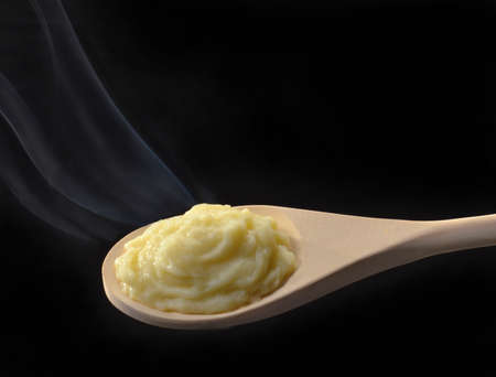Potato puree on wooden spoonの写真素材
