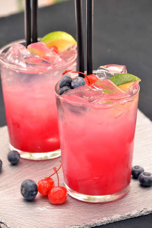 Red cocktail drinks and fruitsの写真素材