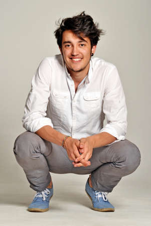Man in casual wear squatting