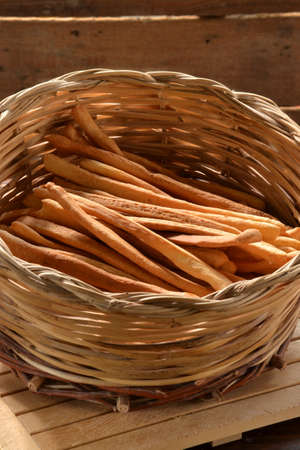 Grissini. fresh bread sticks in a basket on wooden tableの写真素材