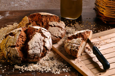 Rustic bread and wheat on an old vintage wood table and chest.