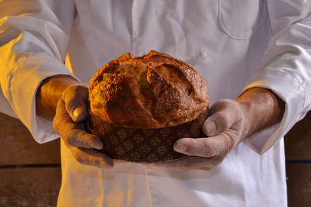 Baker holding panettone bread.の写真素材