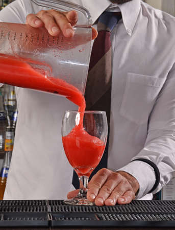 Barman preparing strawberry daiquiri cocktail.の写真素材