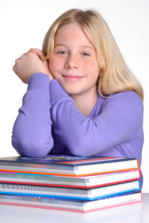 School girl portrait behind books.
