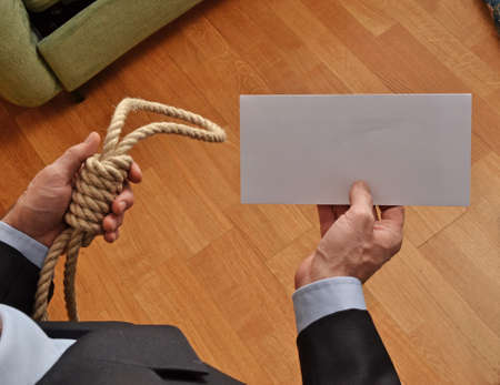 Hangman holding a white chart and letter message.の写真素材