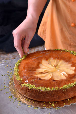 Chef preparing cream cake