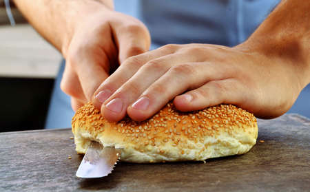 Slicing burger bread and preparing burger.の写真素材