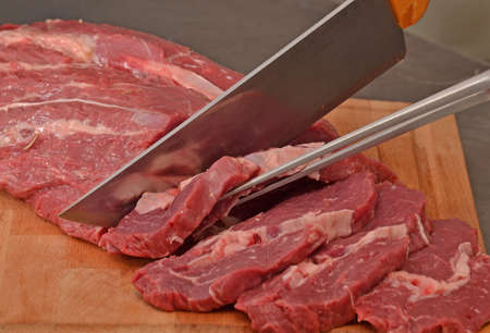 Cutting a piece of fresh meat, cutting meat