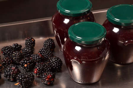 Blackberry jam glass container and fruits. Jam jar.の写真素材