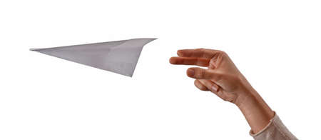 Female hand throwing paper plane isolated on white background.の写真素材
