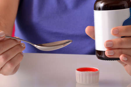 Woman holding bottle with medicineの写真素材