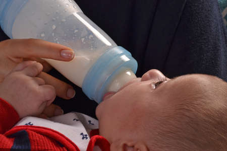Mother feeding baby boy