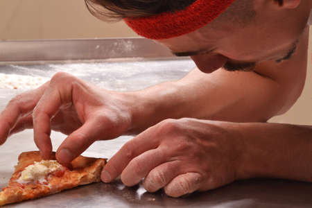 cook preparing pizzaの写真素材