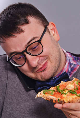 Nerd eating pizzaの写真素材
