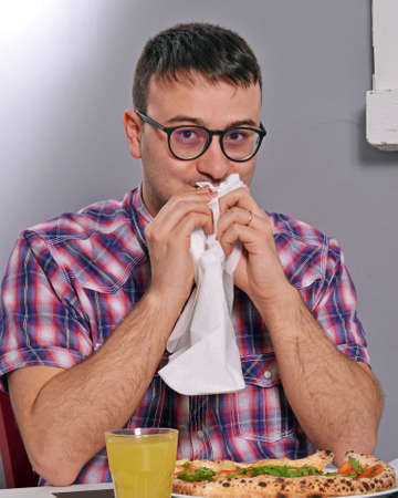 Nerd eating pizzaの写真素材