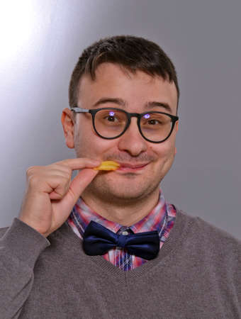 Expressive nerd eating burger
