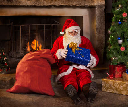 Santa Claus opening giftの写真素材