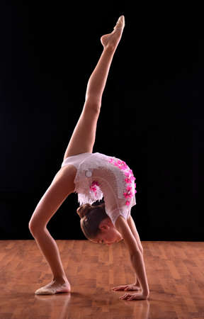Rhythmic gymnastic girl and ring on black background.の写真素材