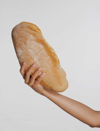 female hand holding big bread