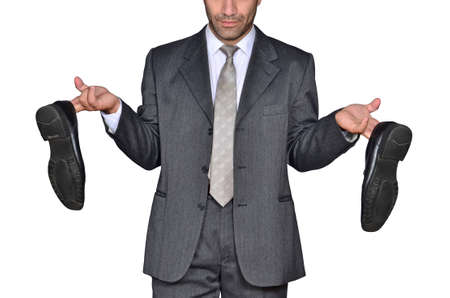 Business man holding shoes, debt concept.の写真素材