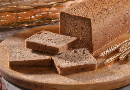 toast wheat wholemeal bread sliced on rustic background.