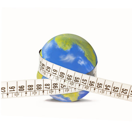 Measuring tape on planet earth globe on white background.の写真素材
