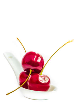 ripe, juicy cherry on spoonの写真素材