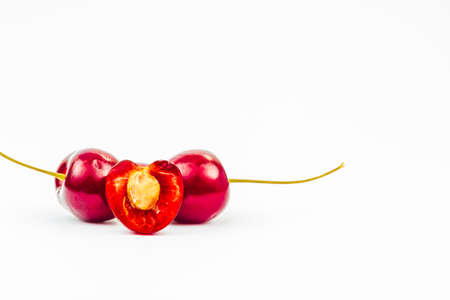 Macro shot of two cherries isolated on white backgroundの写真素材