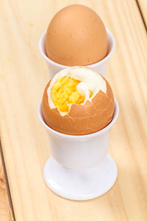 hard boiled eggs on wooden boardの写真素材