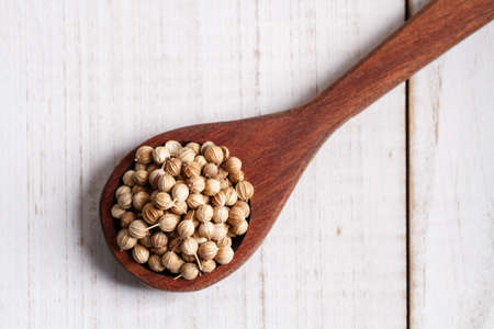 dried coriander on wooden spoonの写真素材