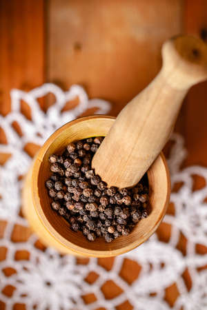 black peppercorns in a mortarの写真素材