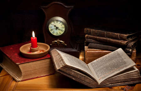 Still life with books, candle, clock and old Greek Gospelのeditorial素材