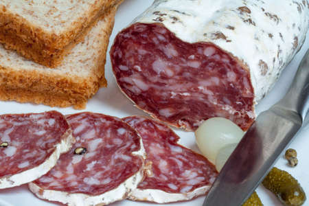 Cut into slices salamiの写真素材