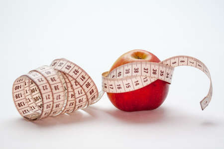 Bicolour apple and tape measureの写真素材
