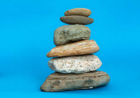 Stacked pebbles on blue backgroundの写真素材